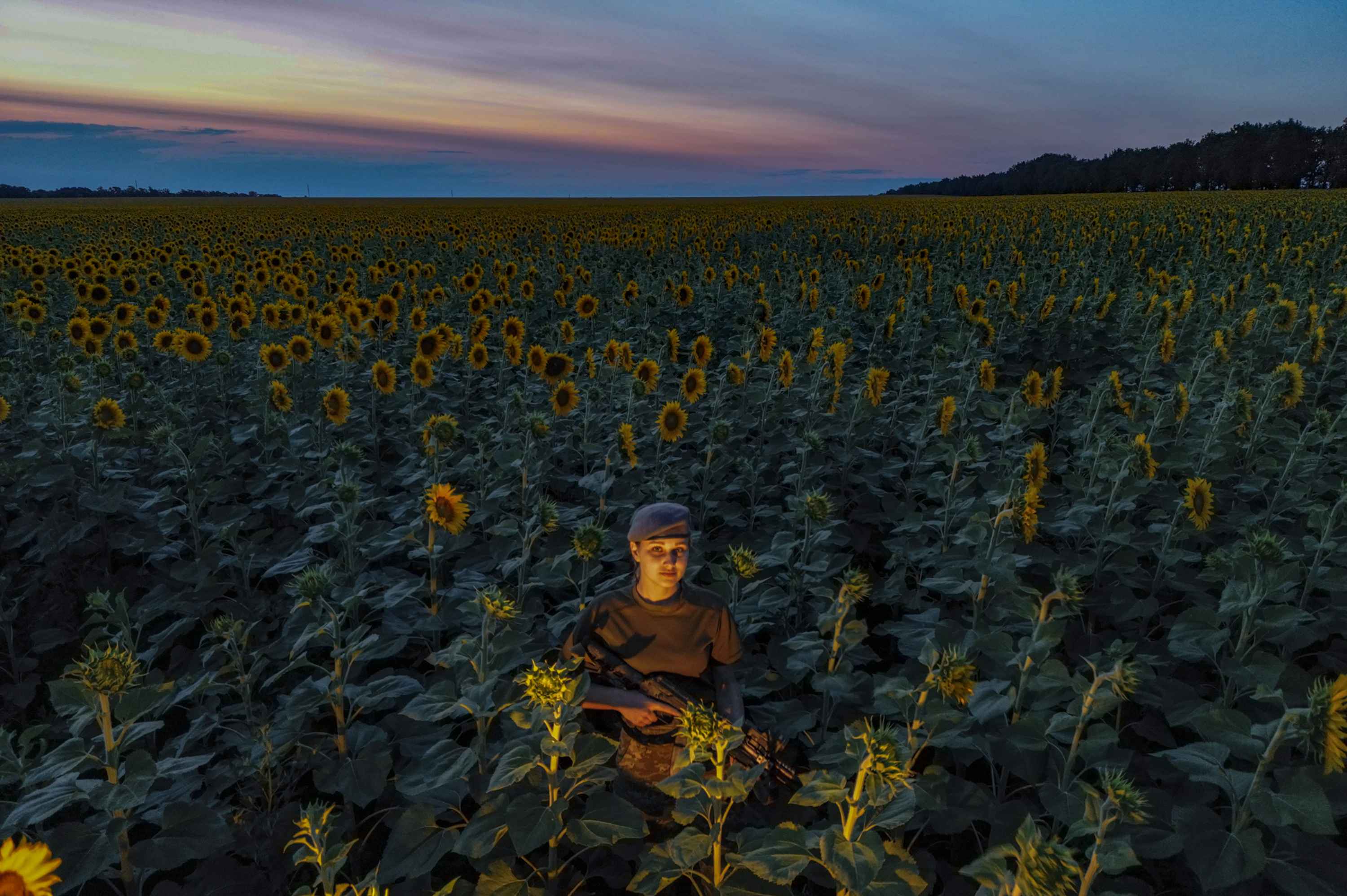 Female soldier in a sunflower field
