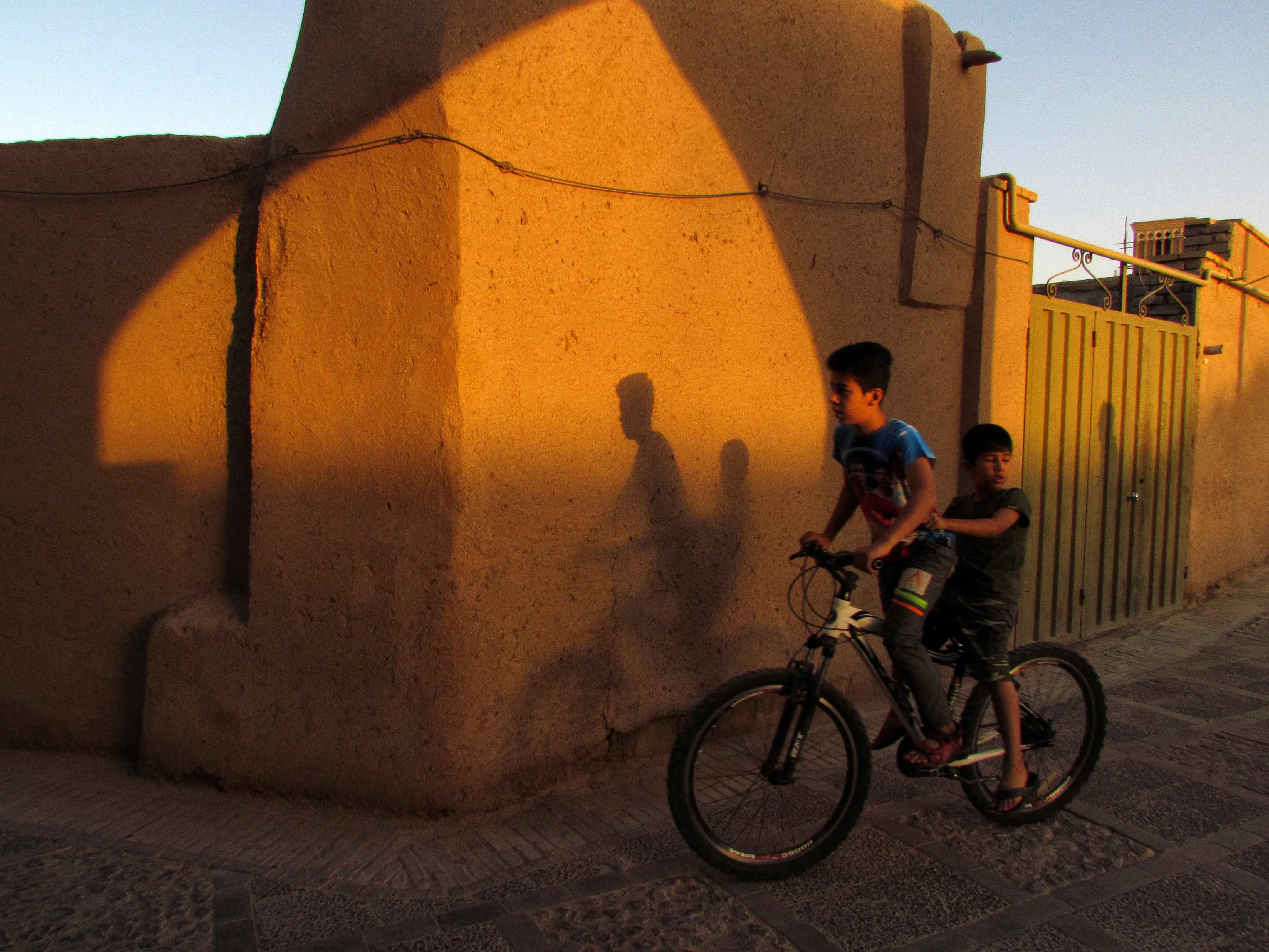 People of old part of Yazd city, Iran, with old houses and structures.