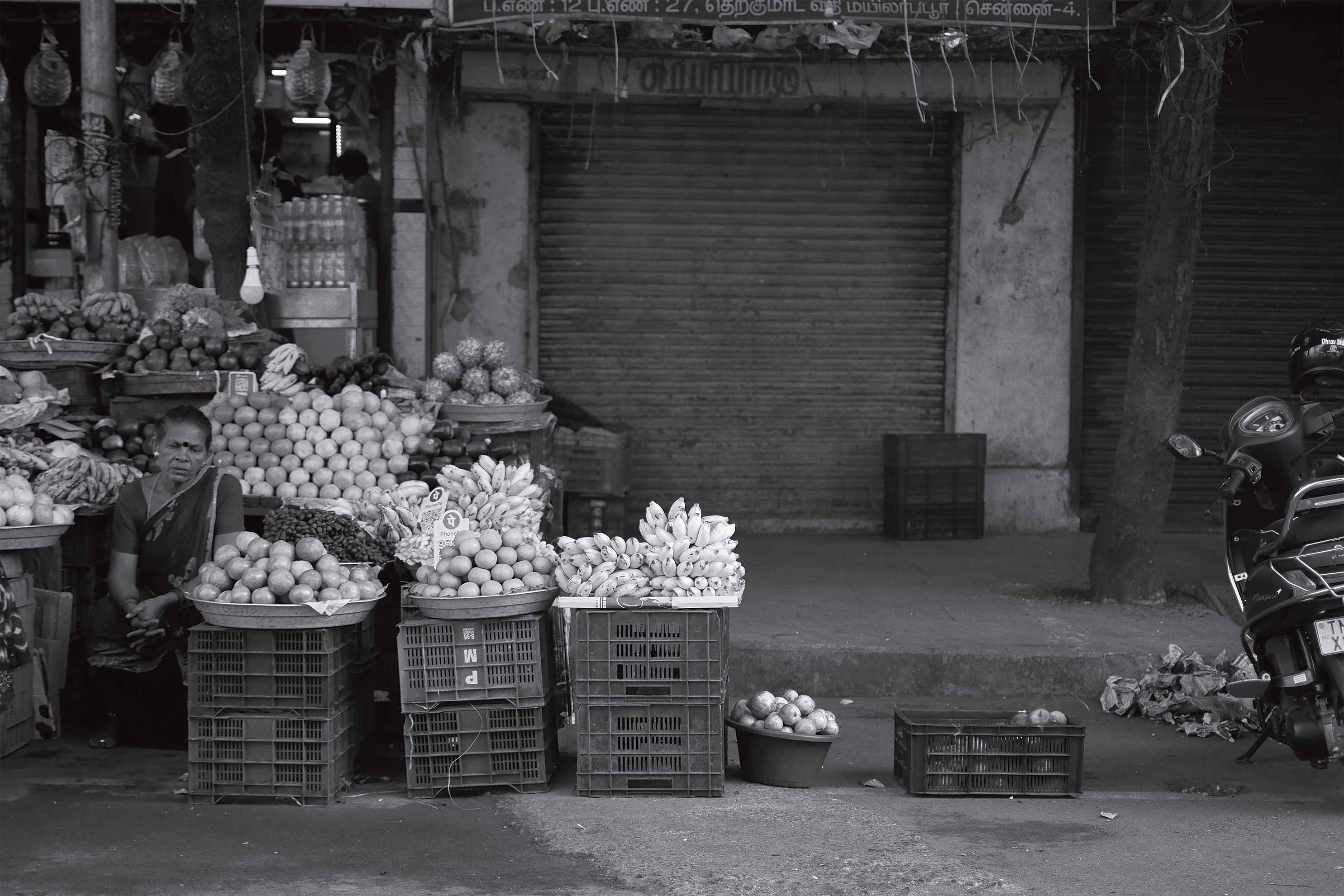 A fruit vendor lost in her thoughts